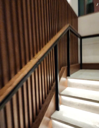 A staircase with a wooden railing.