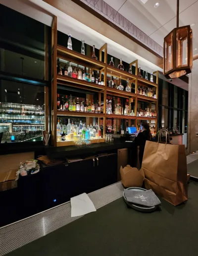 A bar in a hotel with a view of the city.